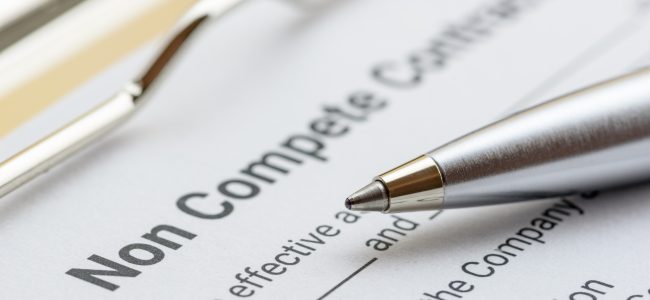 Blue ballpoint pen on a non compete contract. Noncompete contract is an agreement between employee and employer, not to enter into competition in subsequence business effort. Legal concept.