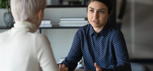 Blogline Post photo. Serious conversation amongst coworkers